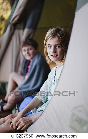 Children sitting in tent at campsite View Large Photo Image Stock Image - Children sitting in tent at campsite. Fotosearch