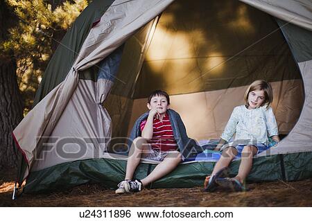 Children sitting in tent at campsite View Large Photo Image Stock Photograph - Children sitting in tent at campsite. Fotosearch