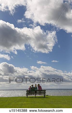 Children sitting on bench at waterfront View Large Photo Image Stock Photo - Children sitting on bench at waterfront. Fotosearch