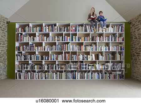 Children sitting on top of bookshelves View Large Photo Image Stock Image - Children sitting on top of bookshelves. Fotosearch