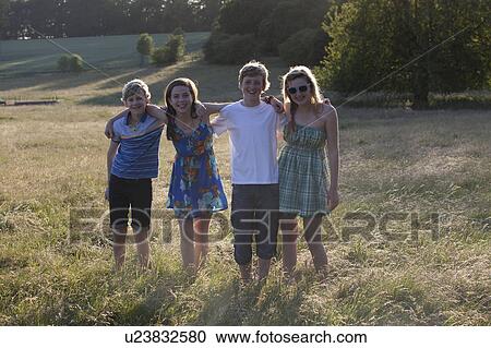 Children standing together in field View Large Photo Image Stock Image - Children standing together in field. Fotosearch
