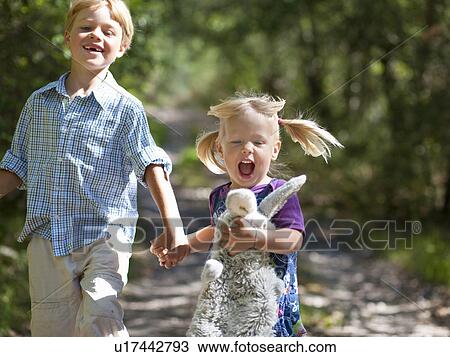 Children walking hand-in-hand outdoors View Large Photo Image Stock Image - Children walking hand-in-hand outdoors. Fotosearch