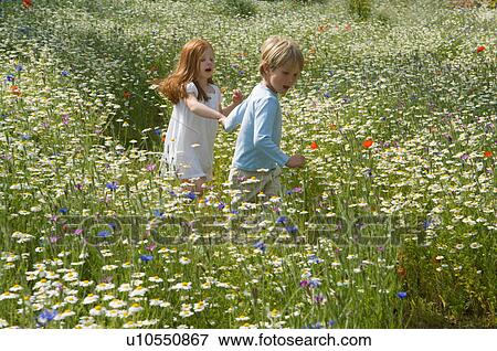 Children walking in field of flowers View Large Photo Image Stock Photo - Children walking in field of flowers. Fotosearch