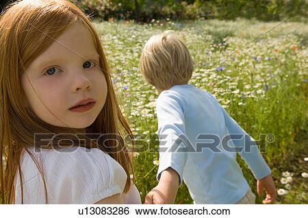 Children walking in field of flowers View Large Photo Image Stock Photograph - Children walking in field of flowers. Fotosearch