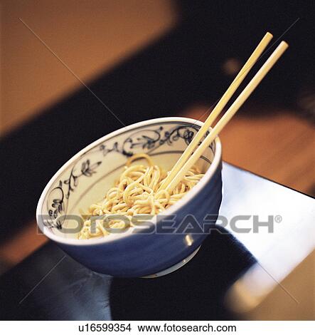 Chopsticks in bowl of noodles View Large Photo Image Picture - Chopsticks in bowl of noodles. Fotosearch