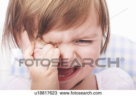 Stock Image - Close up of baby girl crying. Fotosearch