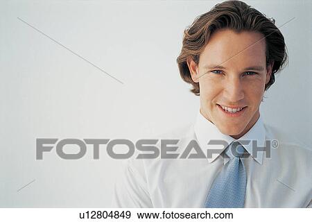 Close up of businessman smiling View Large Photo Image Stock Photo - Close up of businessman smiling. Fotosearch