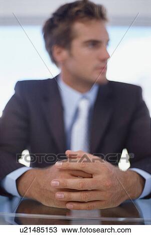 Stock Image - Close up of businessman’s folded hands. Fotosearch