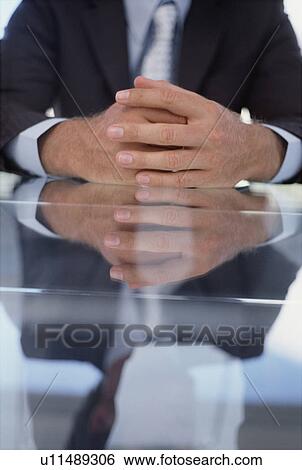Stock Photograph - Close up of businessman’s folded hands. Fotosearch
