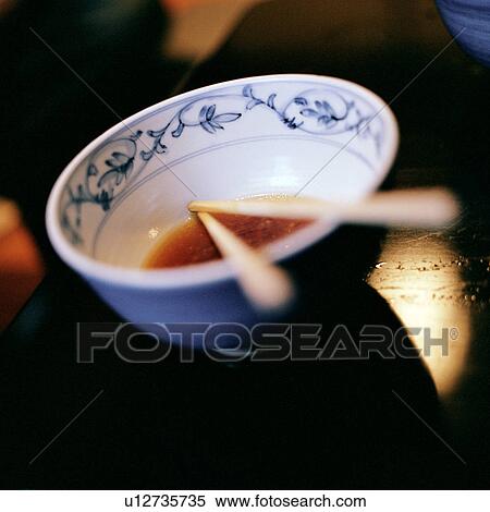 Close up of chopsticks in bowl of soup View Large Photo Image Stock Photography - Close up of chopsticks in bowl of soup. Fotosearch