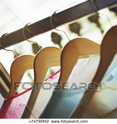 Close up of clothes on hangers View Large Photo Image Stock Image - Close up of clothes on hangers. Fotosearch