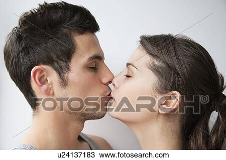 Stock Image - Close up of couple kissing. Fotosearch