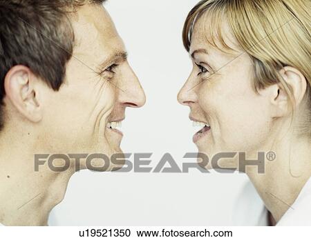 Stock Image - Close up of couple laughing together. Fotosearch