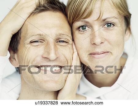 Close up of couple smiling together View Large Photo Image Stock Photo - Close up of couple smiling together. Fotosearch