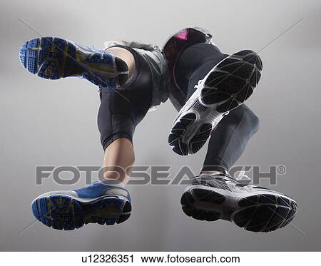 Stock Image - Close up of couple’s running shoes. Fotosearch
