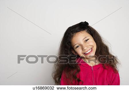 Stock Image - Close up of girl's smiling face. Fotosearch