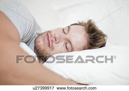 Close up of man asleep in bed View Large Photo Image Stock Photo - Close up of man asleep in bed. Fotosearch