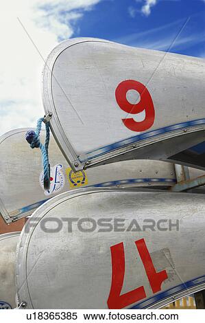 Stock Photography - Close up of numbered canoes. Fotosearch