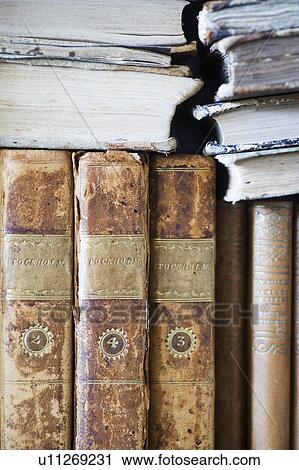 Stock Image - Close up of old leather bound books. Fotosearch