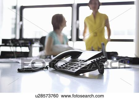 Stock Image - Close up of phone in office. Fotosearch
