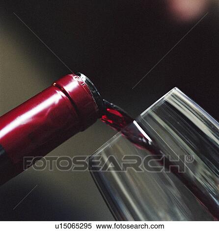 Close up of red wine pouring into glass View Large Photo Image Stock Photography - Close up of red wine pouring into glass. Fotosearch