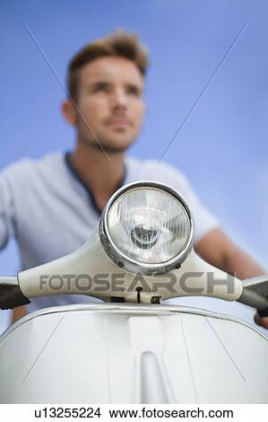 Picture - Close up of scooter headlight. Fotosearch