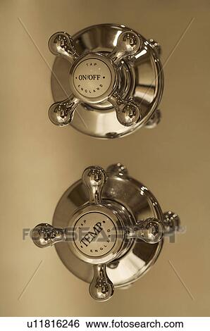 Stock Photograph - Close up of shower faucet handles. Fotosearch