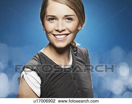 Stock Image - Close up of smiling girl's face. Fotosearch