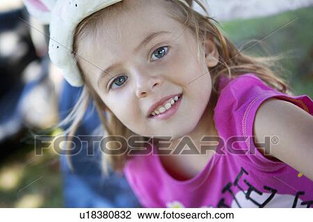 Stock Image - Close up of smiling girl’s face. Fotosearch