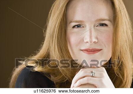 Stock Photograph - Close up of smiling woman’s face. Fotosearch