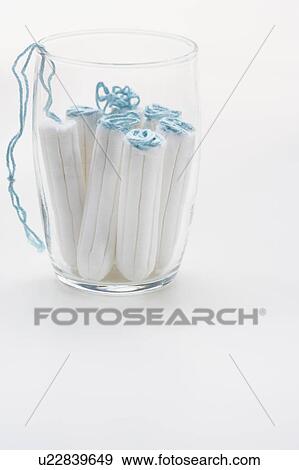 Stock Photo - Close up of tampons in glass. Fotosearch