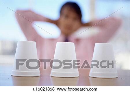 Close up of three cups on office desk View Large Photo Image Stock Photo - Close up of three cups on office desk. Fotosearch