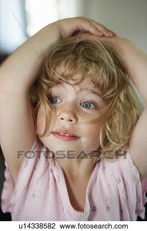 Close up of toddler holding her head View Large Photo Image Stock Image - Close up of toddler holding her head. Fotosearch