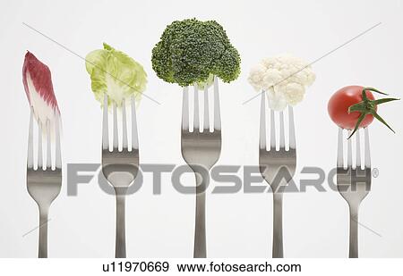 Stock Photo - Close up of vegetables on forks. Fotosearch