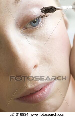 Close up of woman applying mascara View Large Photo Image Picture - Close up of woman applying mascara. Fotosearch