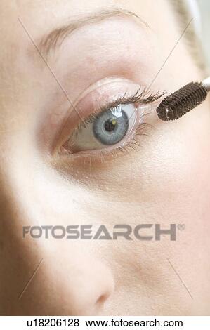 Stock Photo - Close up of woman applying mascara. Fotosearch