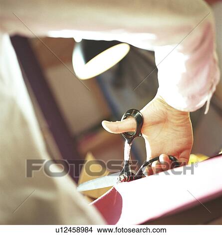 Picture - Close up of woman cutting fabric. Fotosearch