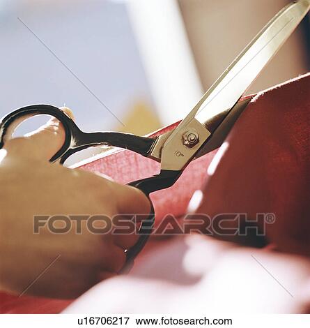 Stock Photo - Close up of woman cutting fabric. Fotosearch