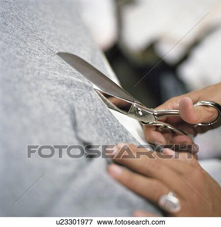 Stock Photo - Close up of woman cutting fabric. Fotosearch