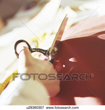 Close up of woman cutting fabric View Large Photo Image Stock Photo - Close up of woman cutting fabric. Fotosearch
