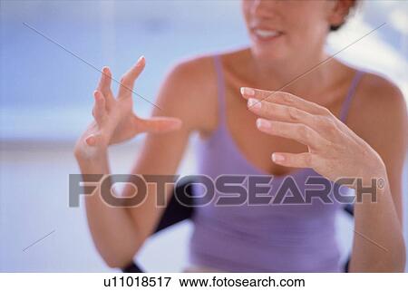 Stock Photo - Close up of woman gesturing and speaking. Fotosearch