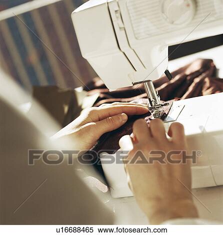 Stock Photography - Close up of woman sewing with machine. Fotosearch
