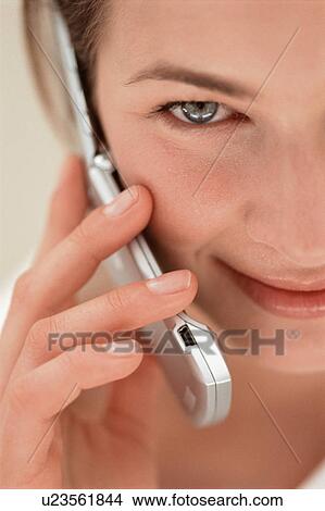 Picture - Close up of woman talking on cell phone. Fotosearch