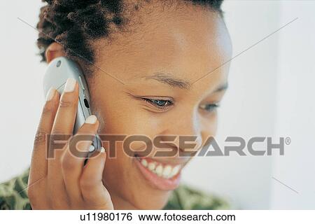 Close up of woman talking on cell phone View Large Photo Image Stock Photograph - Close up of woman talking on cell phone. Fotosearch