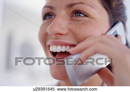 Close up of woman talking on cell phone View Large Photo Image Stock Photography - Close up of woman talking on cell phone. Fotosearch