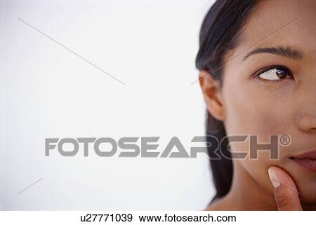 Stock Photo - Close up of woman thinking. Fotosearch