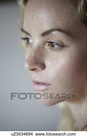 Picture - Close up of woman’s freckled face. Fotosearch
