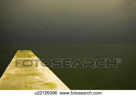 Concrete jetty over still lake View Large Photo Image Stock Photograph - Concrete jetty over still lake. Fotosearch