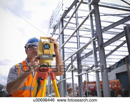 Stock Photograph - Construction worker surveying site. Fotosearch