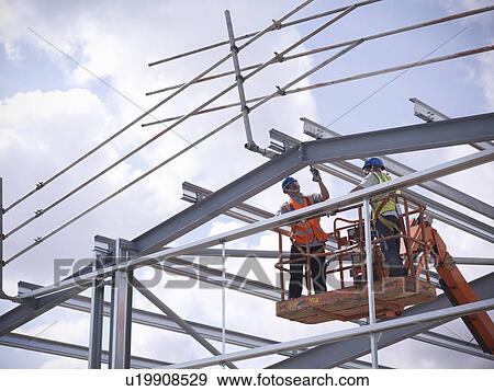 Construction workers in cherry picker View Large Photo Image Stock Photo - Construction workers in cherry picker. Fotosearch